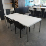White concrete dining room table with brushed stainless steel base